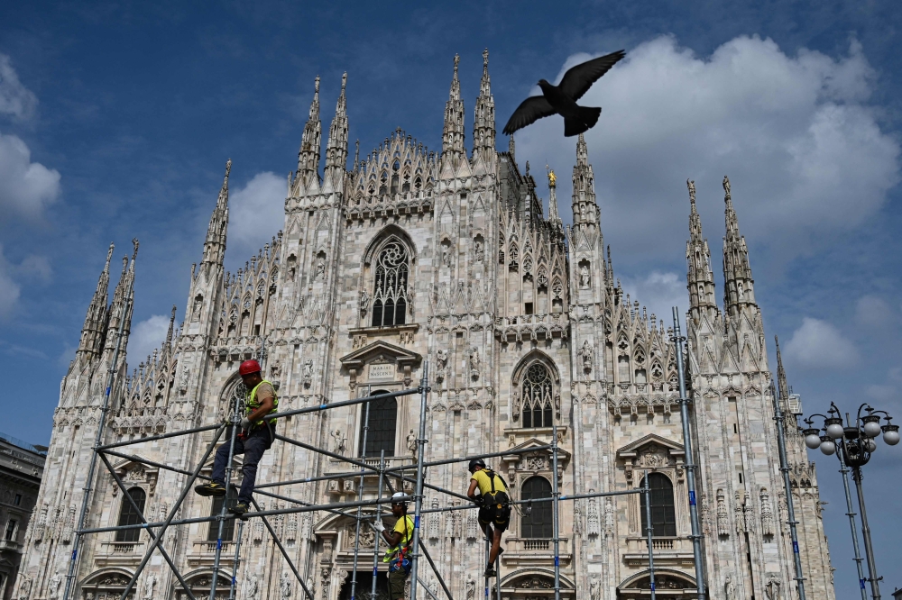 Workers installing scaffolding for a giant screen that will broadcast the state funeral ceremony of former prime minister Silvio Berlusconi. — AFP pic