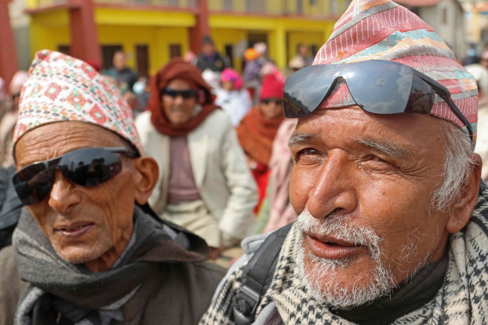 Farmer Rudra Prasad Nepal speaks after his left eye was unbandaged following surgery at a cataract camp in Basantapur. — AFP pic