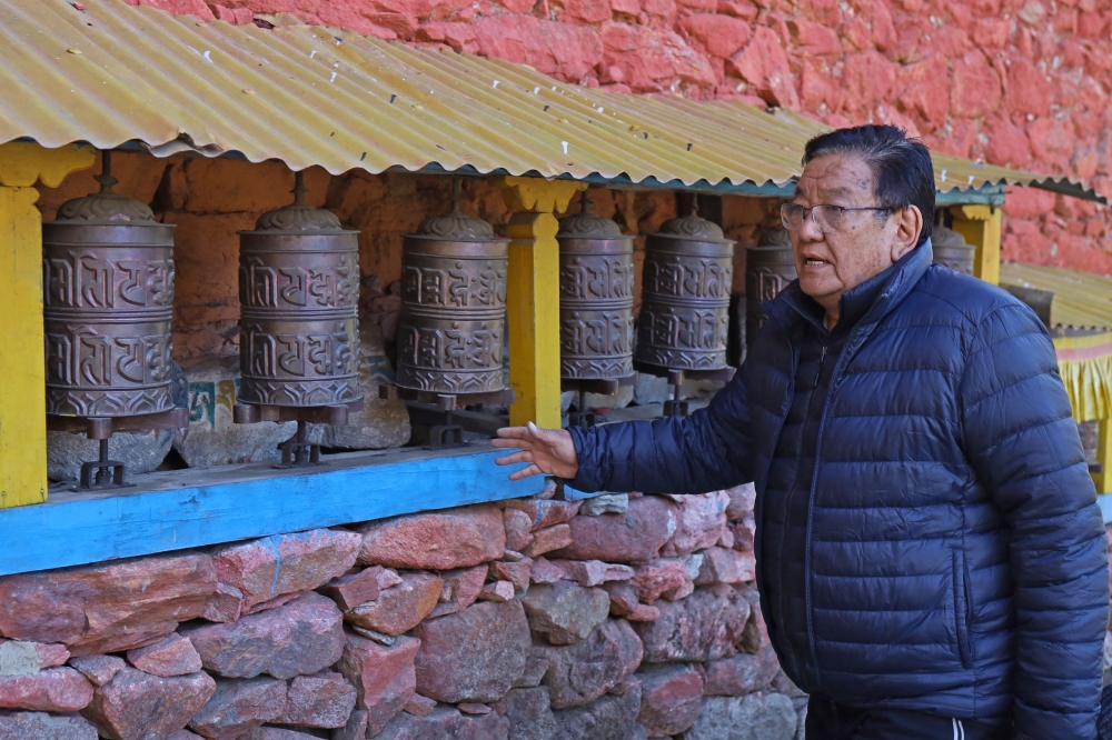 Eye surgeon Sanduk Ruit rotates prayer wheels at the Ngagyur Dikyi Choeling monastery in his childhood home village of Olangchung Gola. — AFP pic
