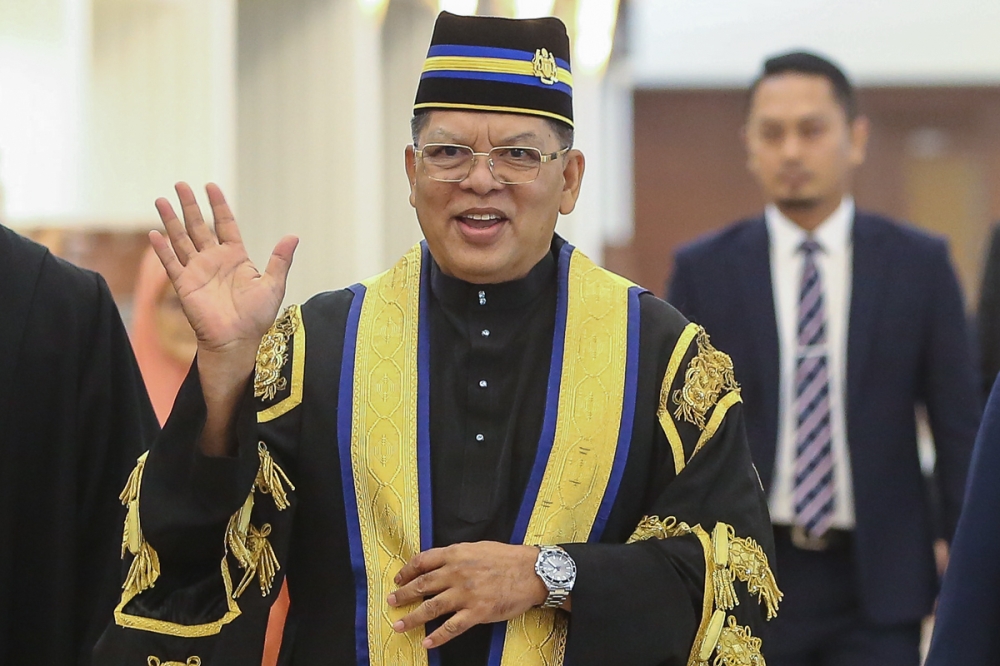 Dewan Rakyat Speaker Datuk Johari Abdul waves to photographers at the Parliament building in Kuala Lumpur on December 19, 2022. — Picture by Yusof Mat Isa