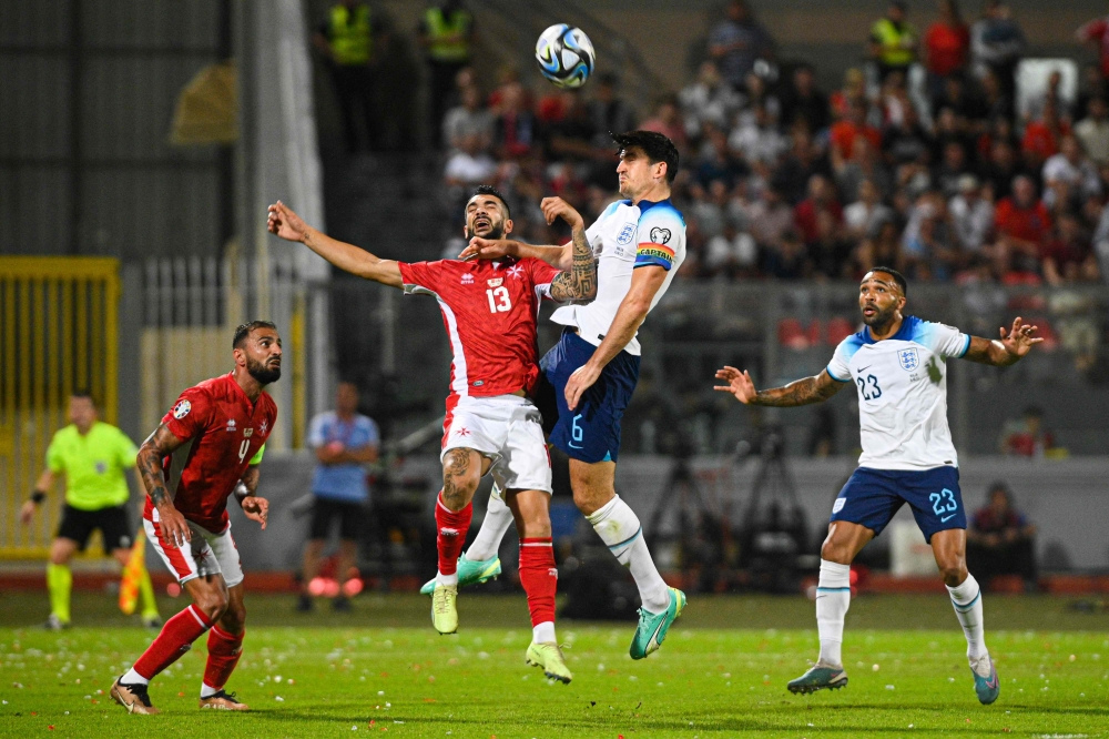 Malta's defender Ferdinando Apap (left) and England's defender Harry Maguire go for a header during the UEFA Euro 2024 Group C qualifiers match between Malta and England at the National Stadium Ta'Qali in Attard, Malta June 16, 2023. — AFP pic