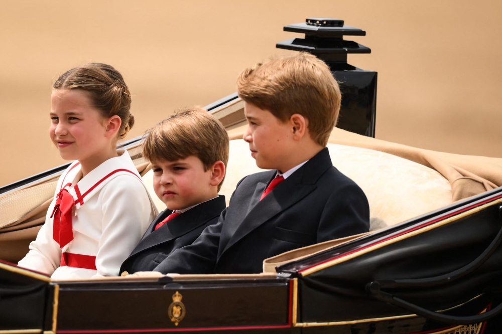 Britain's Prince George of Wales, Britain's Prince Louis of Wales and Britain's Princess Charlotte of Wales arrive in a horse-drawn carriage on Horse Guards Parade for the King's Birthday Parade, 'Trooping the Colour', in London on June 17, 2023. — AFP pic