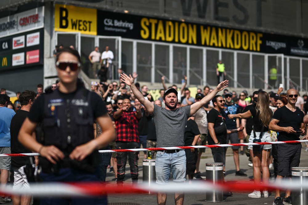 Around 150 protesters gathered outside a Bern stadium yesterday, trying to out-shout thousands of Rammstein fans pouring in to see their favourite band, despite a wave of sexual assault claims. — AFP pic