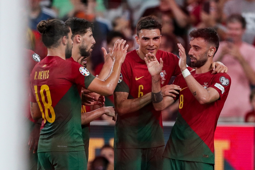 Portugal’s midfielder Bruno Fernandes (right) celebrates with teammates after scoring his team's second goal during the UEFA Euro 2024 group J qualification football match between Portugal and Bosnia-Herzegovina at the Luz stadium in Lisbon on June 18, 2023. — AFP pic