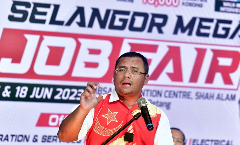 Selangor Menteri Besar Datuk Seri Amirudin Shari delivers a speech while officiating the 2023 Selangor Mega Job Carnival in Shah Alam June 18, 2023. — Bernama pic