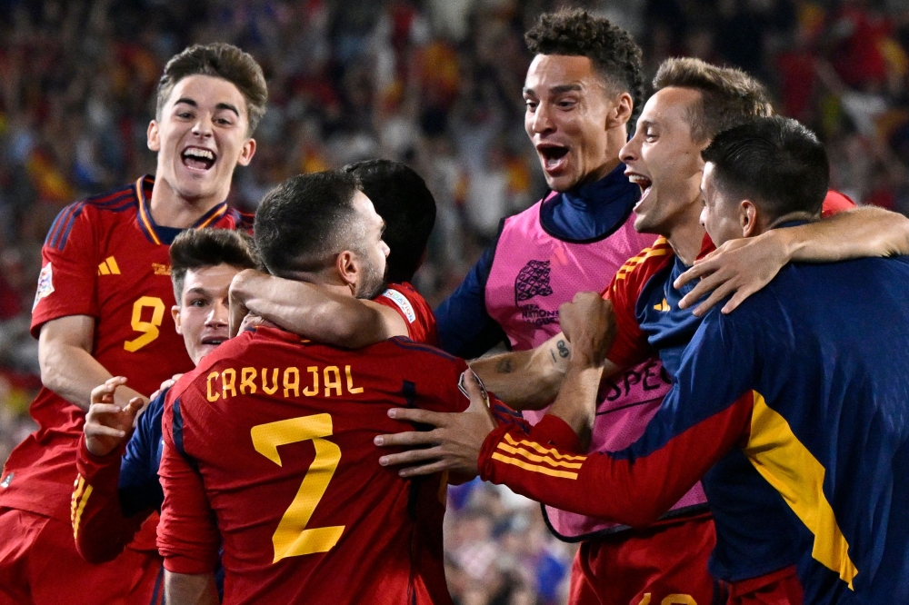 Spain's players including Spain's defender Dani Carvajal (CL) celebrate after winning the penalty shootouts and the UEFA Nations League final football match between Croatia and Spain at the De Kuip Stadium in Rotterdam June 18, 2023. ¬— AFP pic 