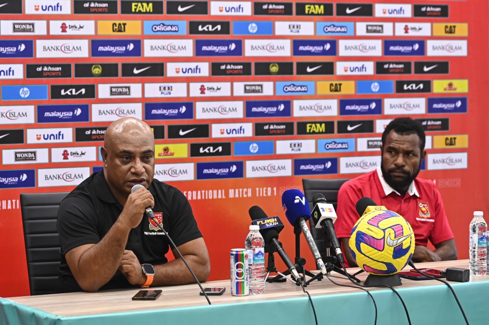 Papua New Guinea’s head coach, Harrison Kamake (left) with his player, Raymond Gunemba at a press conference ahead of the Tier 1 International Friendly match between Malaysia and Papua New Guinea, June 19, 2023. — Bernama pic 