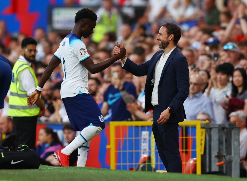 England’s Bukayo Saka shakes hands with manager Gareth Southgate after being substituted during the Uefa Euro 2024 Qualifier Group C match against North Macedonia at Old Trafford, Manchester, Britain, June 19, 2023. — Reuters pic 