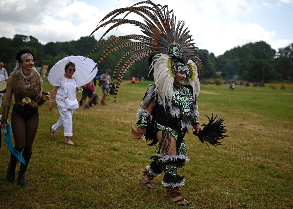 Festival-goers attend the first day of the Glastonbury festival, June 21, 2023. — AFP pic 