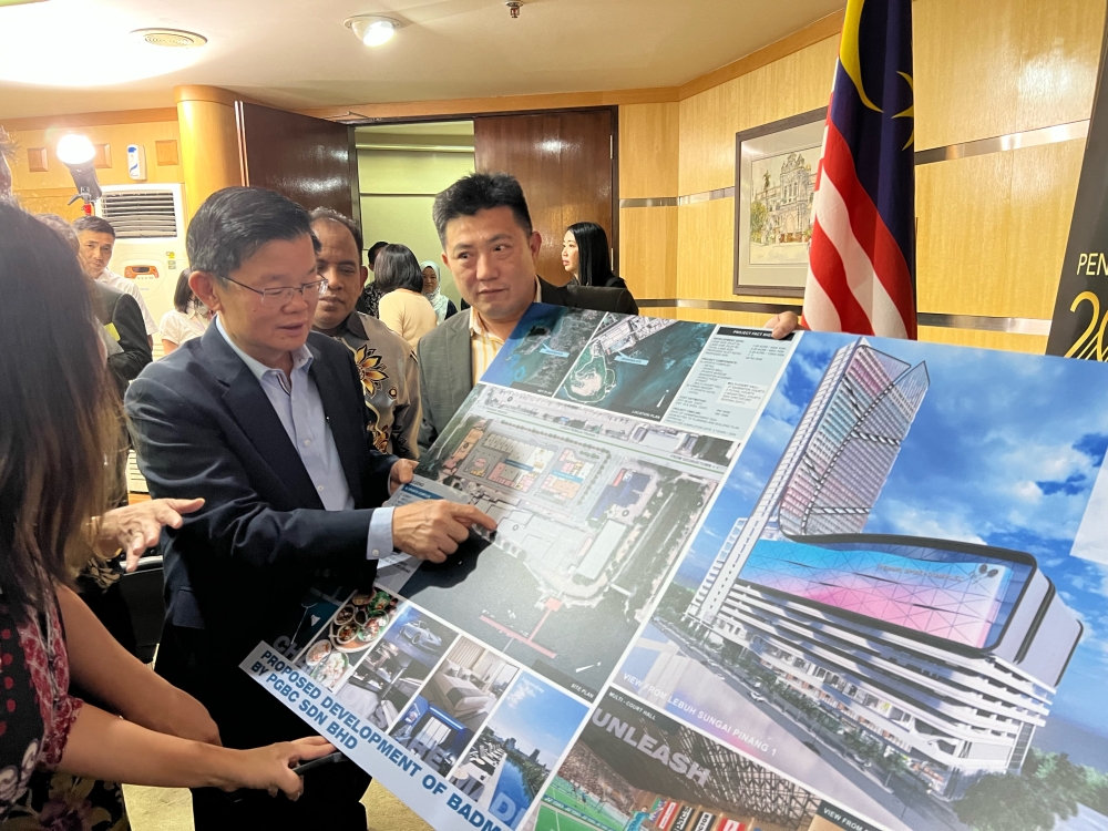 Penang Chief Minister Chow Kon Yeow looking at the plans for the Badminton Academy in George Town June 22, 2023. — Picture by Opalyn Mok