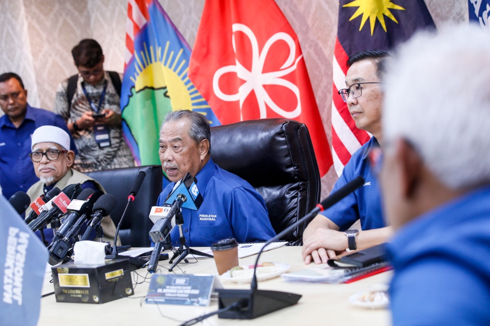 PN chairman Tan Sri Muhyiddin Yassin (centre) is seen with PAS president Tan Sri Abdul Hadi Awang (left) and Gerakan president Datuk Dominic Lau (right) during the press conference at Perikatan Nasional headquarters in Publika Jun 22, 2023. — Photo by Hari Anggara