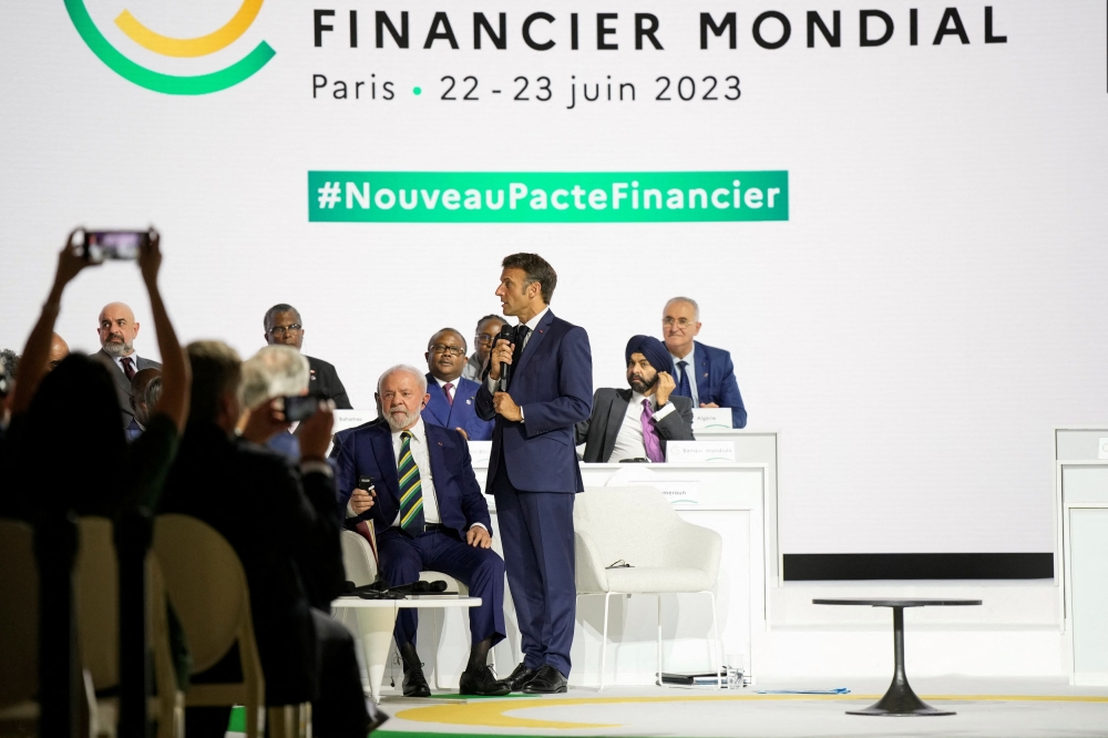 French President Emmanuel Macron speaks during the closing session of the New Global Financial Pact Summit, while Brazilian President Luiz Inacio Lula Da Silva, sitting at center, listens, Friday, June 23, 2023 in Paris. — Lewis Joly/Pool pic via Reuters 