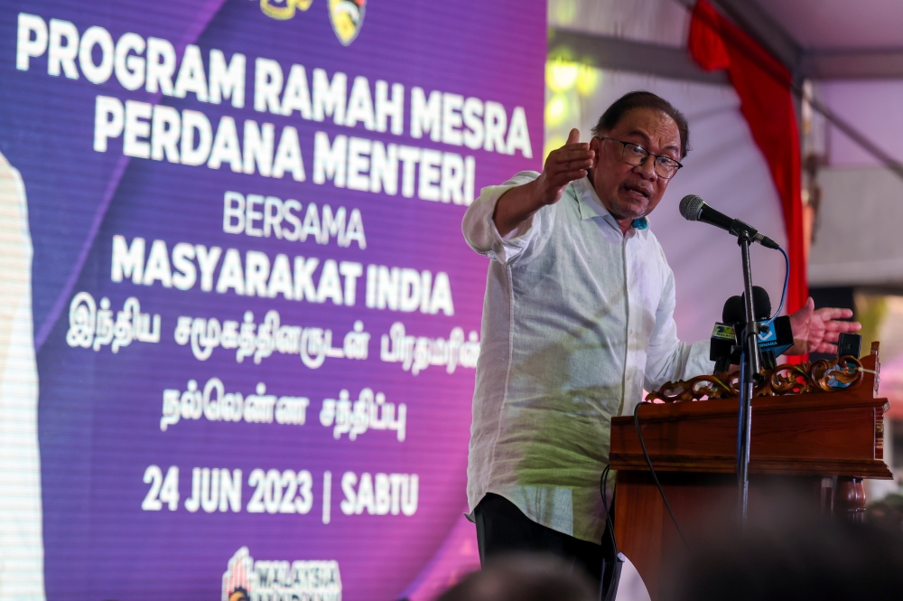 Prime Minister Datuk Seri Anwar Ibrahim delivers a speech at a meet-and-greet session with the Indian community at Desa Cempaka in Nilai June 24, 2023. — Bernama pic