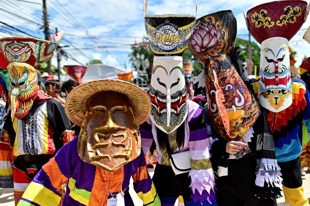 Participants wearing ghost masks and colourful costumes take part in the annual Phi Ta Khon carnival or ghost festival in Dan Sai district in northeastern Thailand’s Loei Province on June 24, 2023. — AFP pic