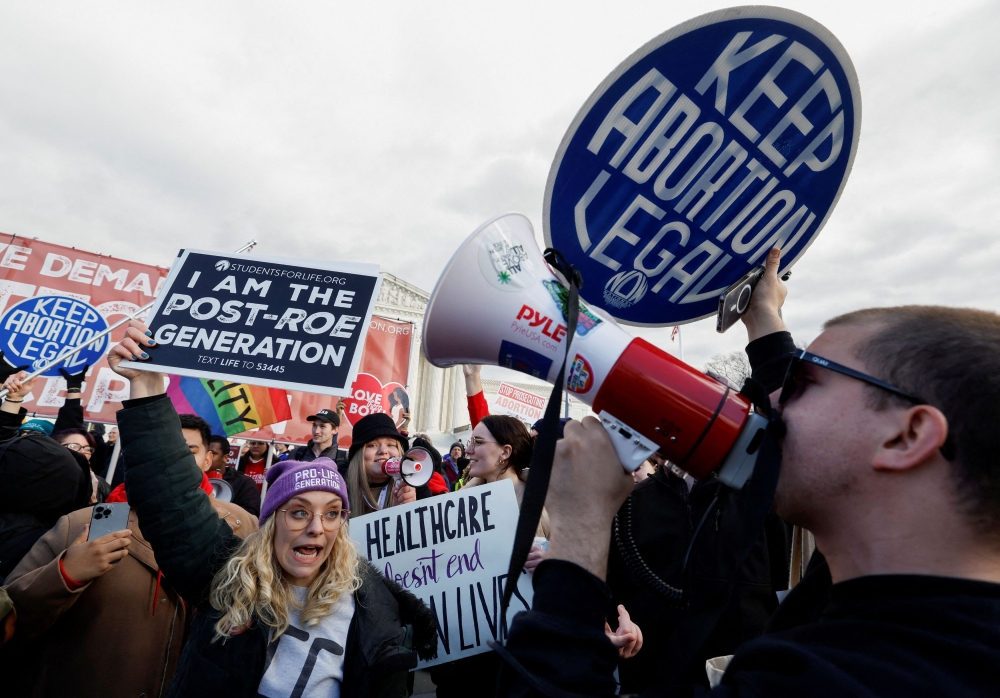 File phot of abortion rights campaigners and anti-abortion demonstrators holding signs during the annual ‘March for Life’ for the first time since the US Supreme Court overturned Roe v Wade abortion decision, in Washington, US January 20, 2023. — Reuters pic