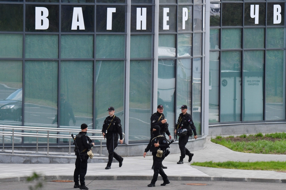 Russian police officers patrol in an area outside PMC Wagner Centre in Saint Petersburg, on June 24, 2023. — AFP pic