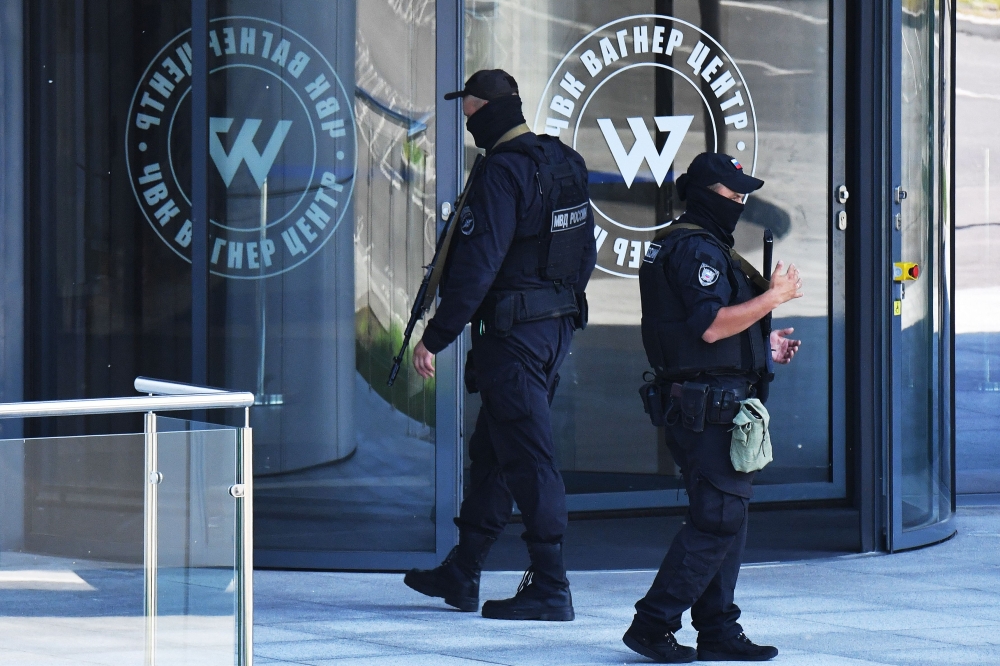 Russian police officers patrol in an area outside PMC Wagner Centre in Saint Petersburg, on June 24, 2023. — AFP pic