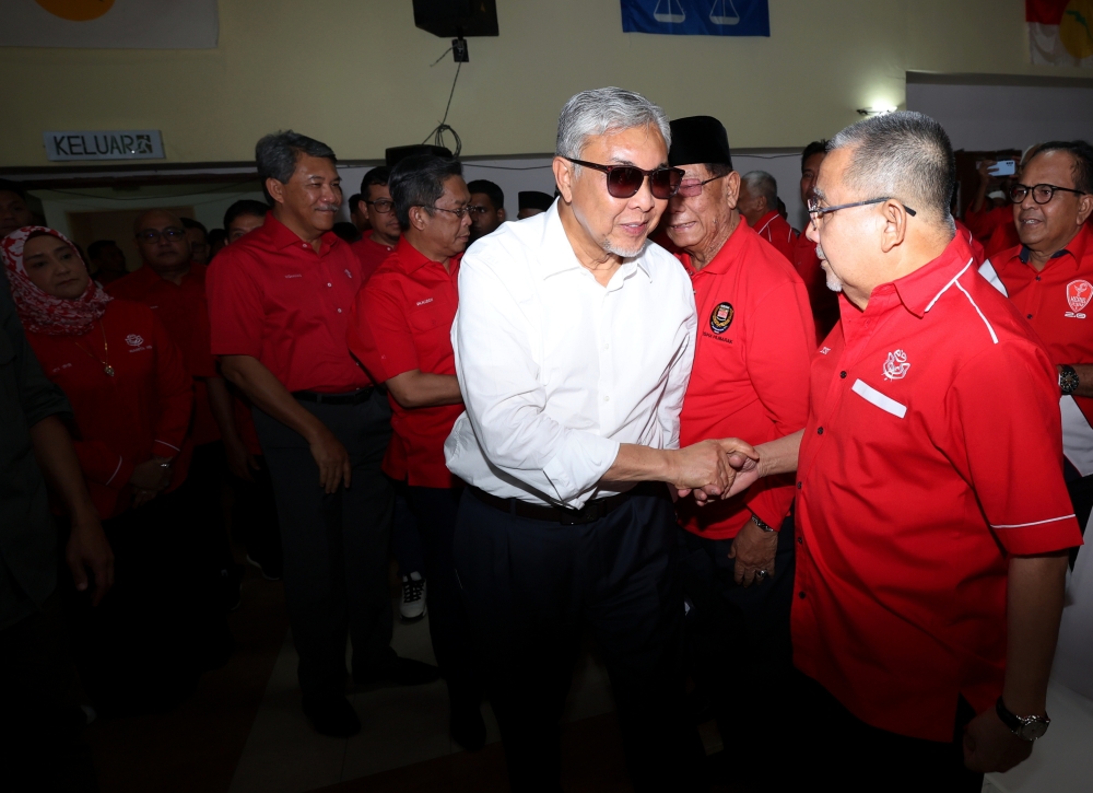 Umno president Datuk Seri Ahmad Zahid Hamidi greets Tan Sri Mohd Isa Abd Samad while attending the Negeri Sembilan Umno machinery meeting in Seremban June 24, 2023. — Bernama pic