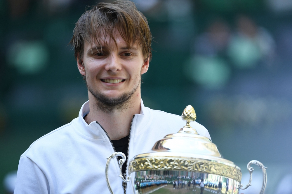 Kazakhstan's Alexander Bublik celebrates with the trophy after winning his final match against Russia's Andrey Rublev. — Reuters pic