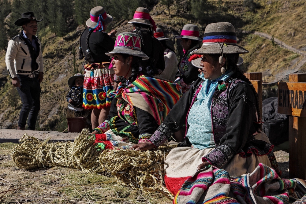 Women participate in the annual renovation of the Q'eswachaka rope bridge. — AFP pic