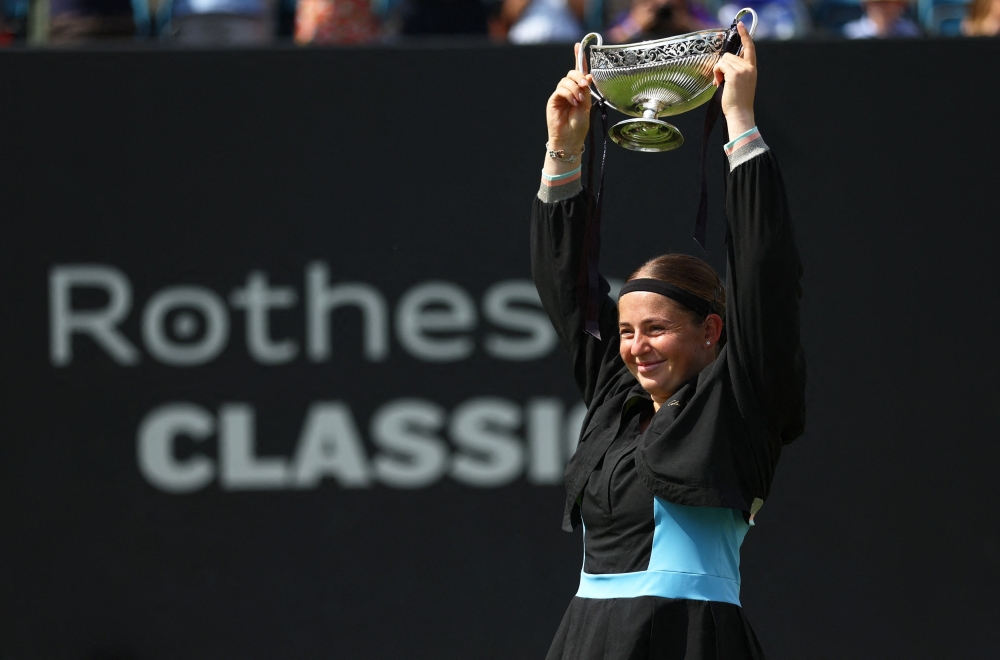 Latvia's Jelena Ostapenko celebrates with the trophy after winning her final match against Czech Republic's Barbora Krejcikova at the Edgbaston Priory Club in Birmingham June 25, 2023. — Reuters pic