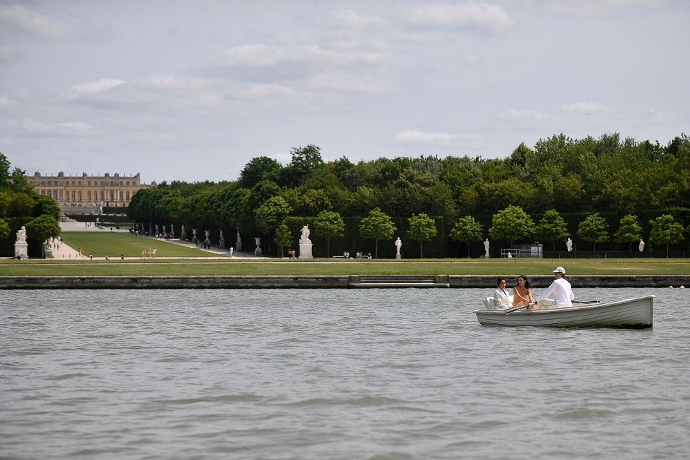 Actress and director Eva Longoria (left) and model Isabela Rangel Grutman (centre) arrive by row-boat at the Jacquemus Menswear Spring-Summer 2024 show. — AFP pic