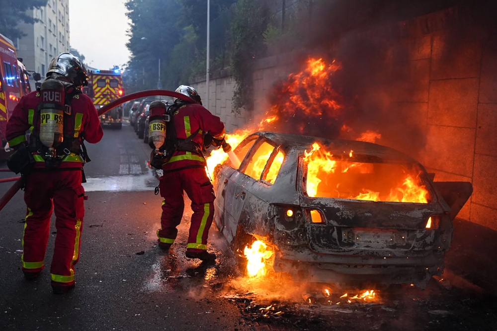 Yesterday evening, protesters in Nanterre lit fires, set a car alight, and destroyed bus stops as tensions soared between police and locals. — AFP pic