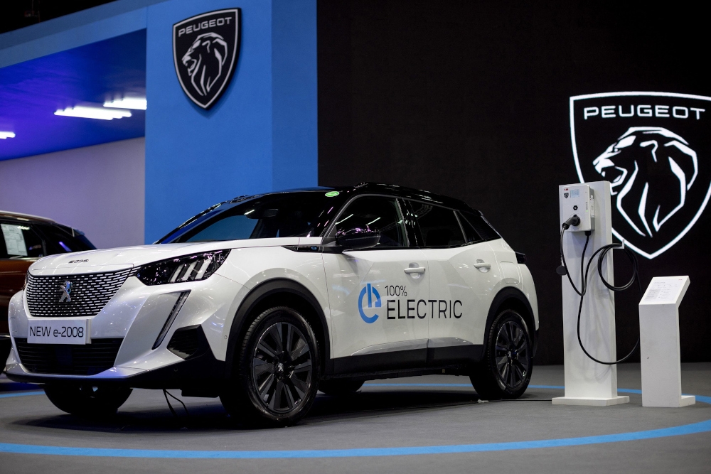 A Peugeot e-2008 electric car and charger is displayed at the 44th Bangkok International Motor Show in Bangkok on March 22, 2023. — AFP pic 