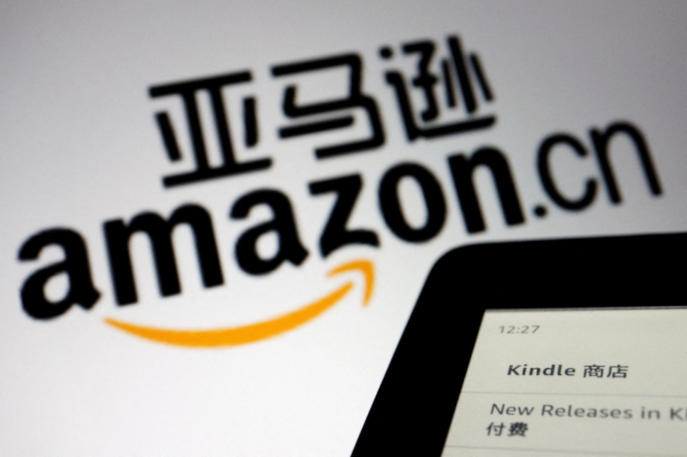 The sign of e-commerce website Amazon China is seen next to a Kindle e-reader displayed in this illustration, taken on December 15, 2021. — Reuters pic