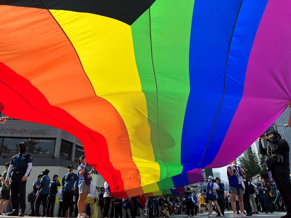 Seoul Queer Culture Festival participants hold a huge rainbow flag during parade in Seoul, South Korea, July 1, 2023. — Reuters pic