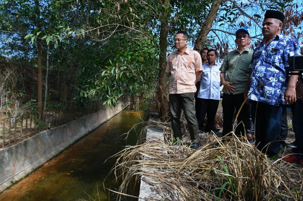 Natural Resources, Environment and Climate Change Minister Nik Nazmi Nik Ahmad (left) during a visit the project site to build and upgrade the sewage system in Kelantan near Taman Wadi Iman, Kok Lanas July 3, 2023. — Bernama pic