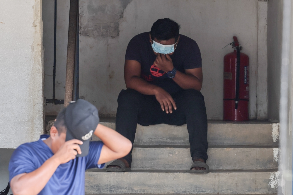 A family member of the 10 individuals who died in the water surge phenomenon sits down after identifying one of the bodies at the operations centre at Air Putih police station in Chukai, Terengganu, July 3, 2023. — Bernama pic 