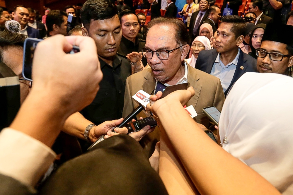 Prime Minister Datuk Seri Anwar Ibrahim speaks to reporters after the launch of the book 'Adab Perbezaan Pendapat Dalam Islam' here at the Jakim Auditorium in Kompleks Islam Putrajaya July 4, 2023. — Picture by Sayuti Zainudin