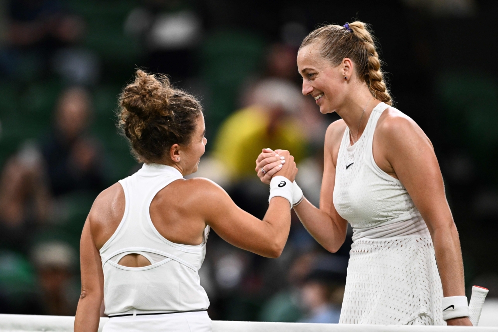Czech Republic's Petra Kvitova (right) shakes hands with Italy's Jasmine Paolini after winning  their women's singles tennis match on the third day of the 2023 Wimbledon Championships at The All England Tennis Club in Wimbledon, southwest London July 5, 2023. — AFP pic