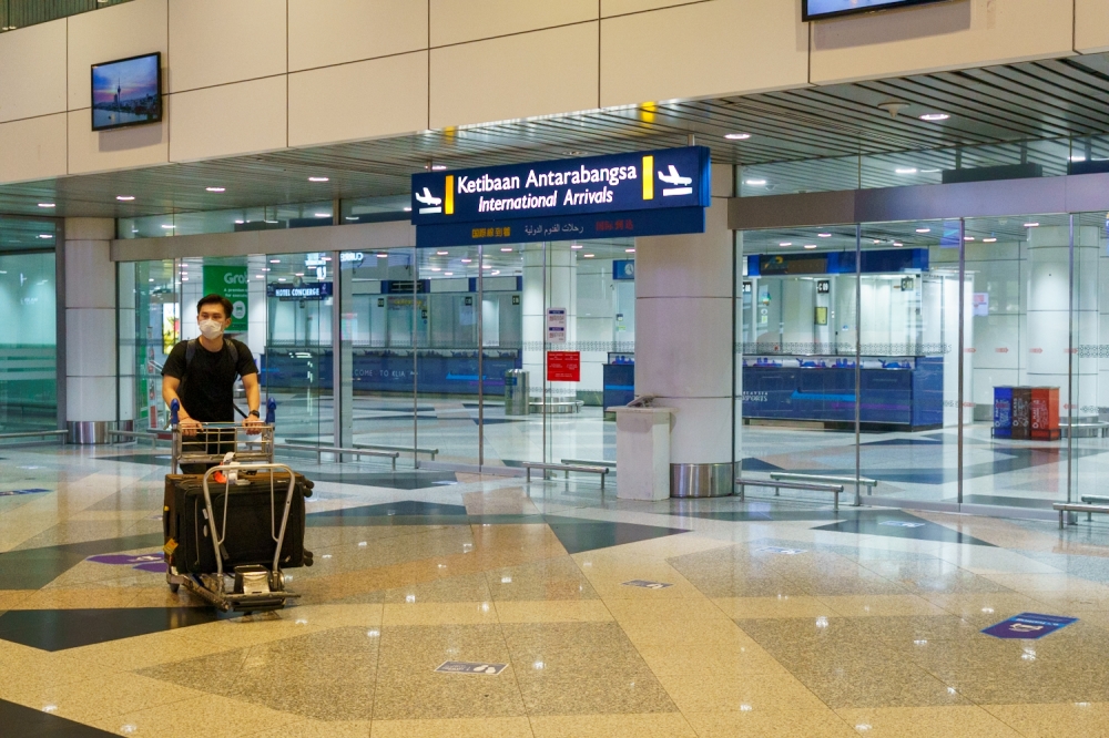 File picture of a passenger at the KLIA arrival hall. MAHB today said that it did not handle Not To Land passengers at Kuala Lumpur International Airport and that the task fell to an independent company appointed by the KLIA Airline Operators Committee. — Picture by Devan Manuel