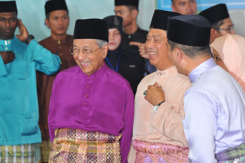Tun Dr Mahathir Mohamad, Tan Sri Muhyiddin Yassin and Datuk Seri Azmin Ali chat during the prime minister’s Aidilfitri open house in Putrajaya in this file picture taken on June 15, 2018. — Picture by Shafwan Zaidon