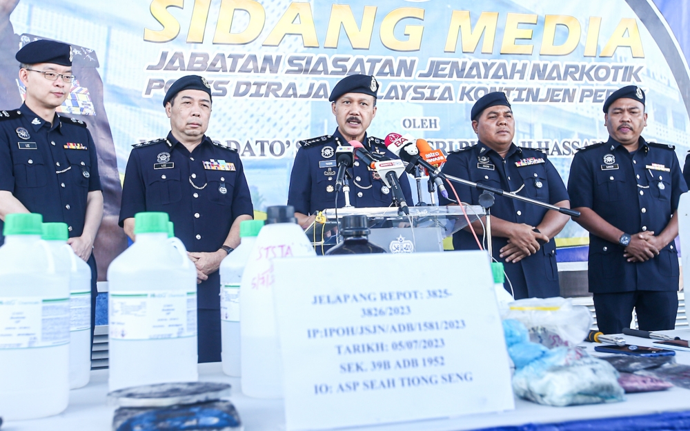 Perak police chief Datuk Seri Mohd Yusri Hassan Basri showing the drugs seized from a drug processing laboratory in Jelapang, at a press conference at the Perak Police Headquarters in Ipoh. — Picture by Farhan Najib