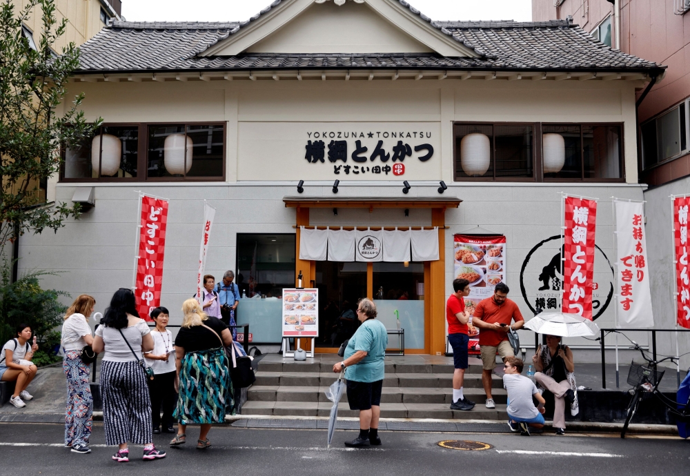Pelancong dari luar negara menunggu Yokozuna Tonkatsu Dosukoi Tanaka, sebuah restoran bertema gusti sumo untuk dibuka, di Tokyo, Jepun 30 Jun, 2023. — Gambar Reuters