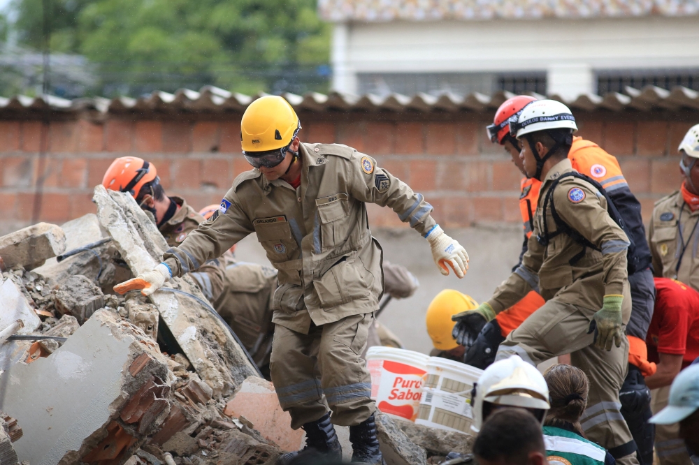 Rescue workers look for victims among debris of a building collapse in Recife, Pernambuco state, Brazil. — Reuters pic