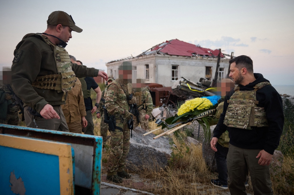 In this handout photograph released by the Ukrainian Presidency on July 8, 2023, Ukraine’s President Volodymyr Zelensky (right) and Head of Ukraine’s military intelligence Kyrylo Budanov (left) visit the Snake Island (Zmiinyi Island), Odesa region, Ukraine. Ukrainian President Volodymyr Zelensky has visited a Black Sea island whose defenders famously defied a Russian warship at the beginning of the invasion, as the conflict reaches its 500th day. — AFP pic