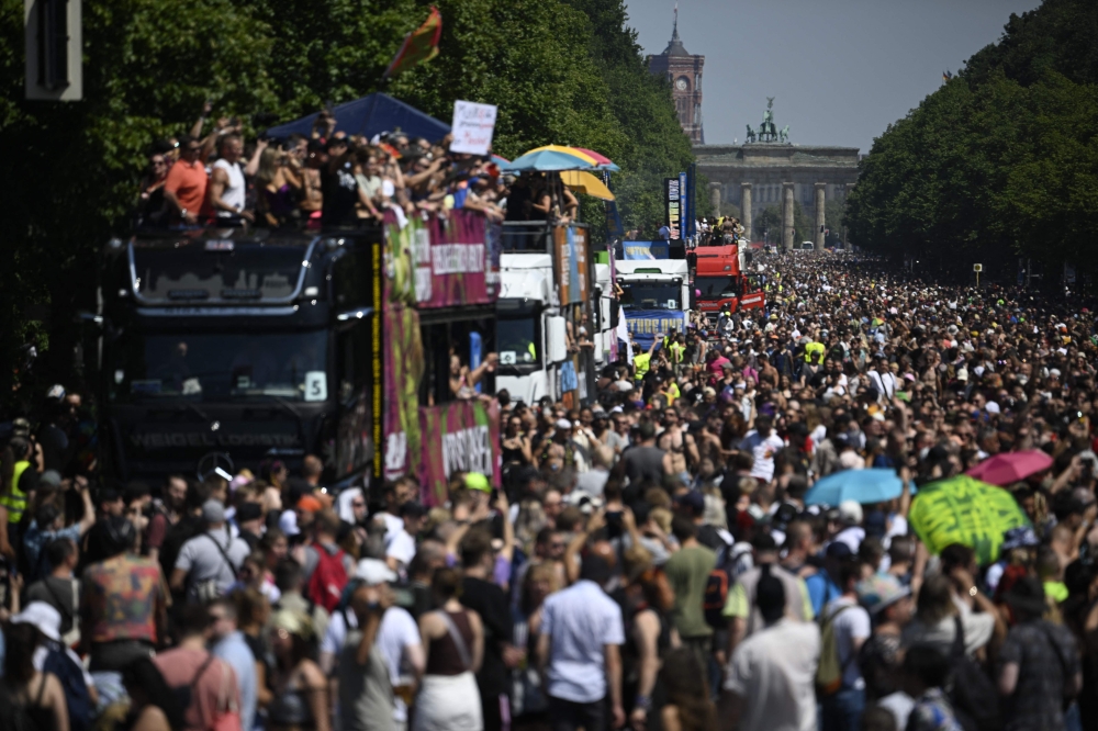 Participants pass the capital’s landmark Brandenburg Gate as they celebrate during the ‘Rave the Planet’ techno music parade in Berlin July 8, 2023. —  AFP pic