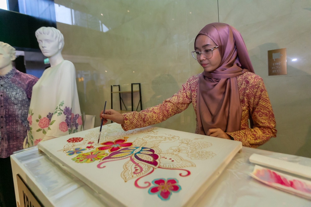 A woman demonstrates the craft of batik during the Tourism Malaysia Buka puasa event at Pavilion Hotel in this file picture taken on April 13, 2023. — Picture by Raymond Manuel