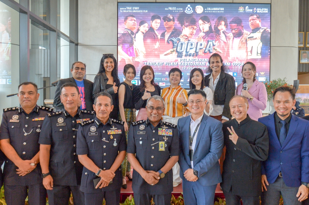 (Front 4th from left) Bukit Aman Commercial Crime Investigation Department director, Datuk Seri Ramli Mohamed Yoosuf takes a group photo with the cast during the launch of film trailer ‘Oppa’ at KL Wellness Gallery, Kuala Lumpur, July 12, 2023. — Picture by Shafwan Zaidon
