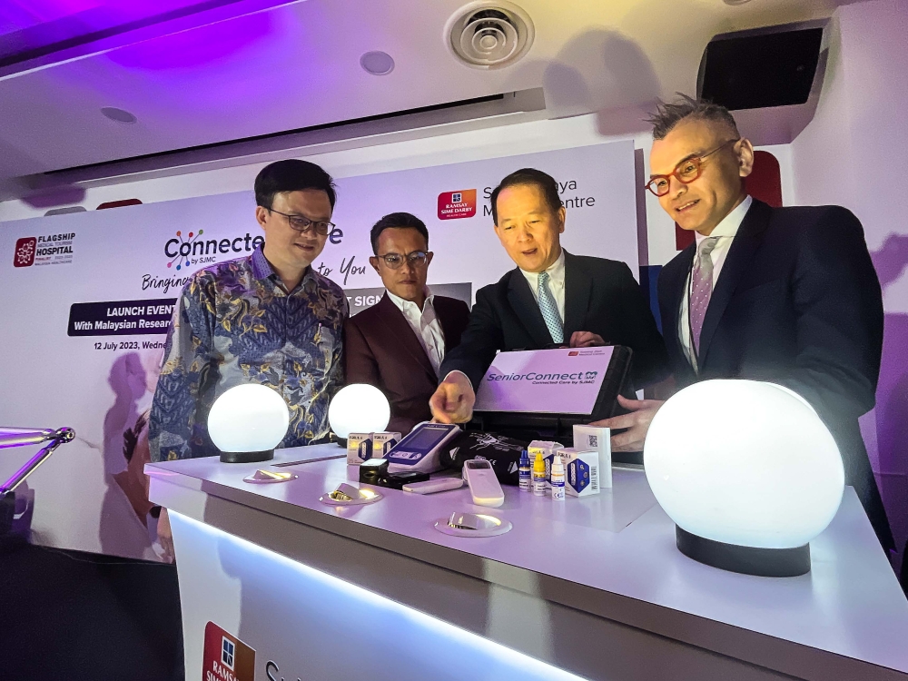 SJMC CEO Bryan Lin (2nd right) with Malaysia Healthcare Travel Council acting CEO Farizal Jaafar (right), Malaysian Research Accelerator for Technology and Innovation CCO Khairil Anuar Sadat Salleh (2nd left) and Ramsay Sime Darby Health Care Sdn Bhd Group CEO Peter Hong (left) looking at the SeniorConnect apparatus during the Connected Care launch ceremony at Subang Jaya Medical Centre, July 12, 2023. — Picture by Sayuti Zainudin