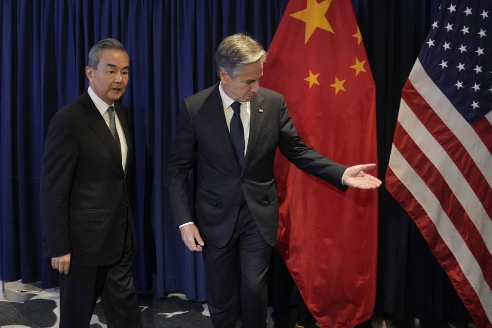 US Secretary of State Antony Blinken (right) shows the way to Director of the Office of the Foreign Affairs Commission of the Communist Party of China's Central Committee Wang Yi during their bilateral meeting on the sidelines of the Association of Southeast Asian Nations (Asean) Foreign Ministers’ Meeting in Jakarta on July 13, 2023. — AFP pic