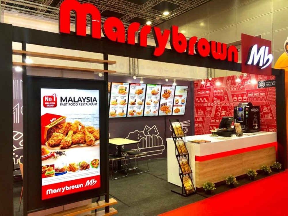 Domestic Trade and Cost of Living Ministry secretary-general Datuk Azman Mohd Yusof said 10 Malaysian brands — Marrybrown, Kenny Rogers Roasters, US Pizza, Cleanpro Express, Deemcee, Global Art, UCMAS, HOME, Q-dees and Little Caliph — are participating in TFBO held from July 13-16 at the Bangkok International Trade and Exhibition Centre. — Picture via Facebook/Marrybrown