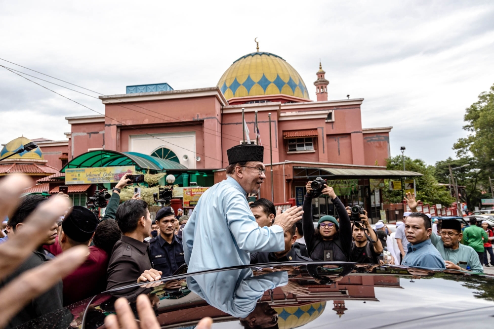 Prime Minister Datuk Seri Anwar Ibrahim greets members of the public as he leaves the Masjid Al-Khairiyah, Taman Sri Gombak after Friday prayers in Selangor July 14, 2023. — Picture by Firdaus Latif