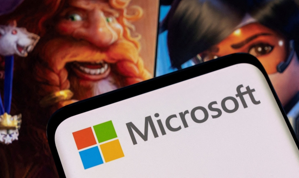 Microsoft logo is seen on a smartphone placed on displayed Activision Blizzard's games characters in this illustration taken January 18, 2022. — Reuters pic