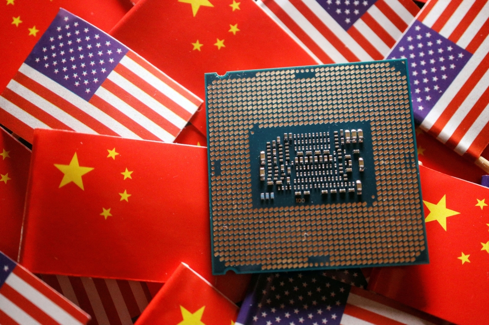 A central processing unit (CPU) semiconductor chip is displayed among flags of China and US, in this illustration picture taken February 17, 2023. ― Reuters pic