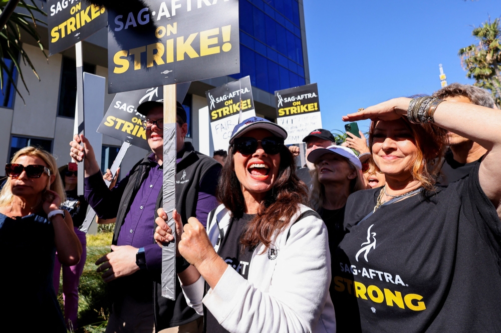 SAG-AFTRA union President Fran Drescher and Duncan Crabtree-Ireland, SAG-AFTRA National Executive Director and Chief Negotiator, demonstrate as SAG-AFTRA actors join the Writers Guild of America (WGA) in a strike against the Hollywood studios, on the picket like outside of Netflix offices in Los Angeles July 14, 2023.  — Reuter pic